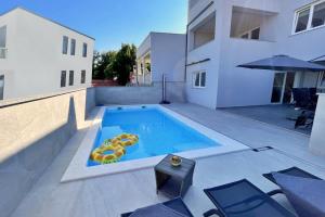 a swimming pool with two inflatable snakes in it at Apartment Bonum with Private Pool in Šilo