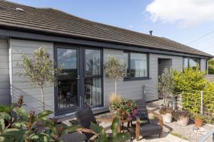 a house with black and white windows at Ocean Drive Boutique Apartment with use of Day time Beach Hut in Brean