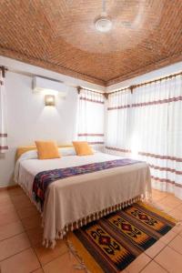 a bedroom with a large bed in a room at Hidden Gem! Charming 2 Bedroom Vacation Home! in Puerto Escondido