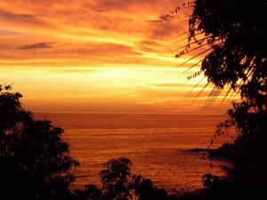 a view of the ocean at sunset at Hidden Gem! Charming 2 Bedroom Vacation Home! in Puerto Escondido