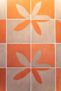 a tiled floor with orange and white tiles at Casa Rita! Relaxing two bedroom getaway! in Puerto Escondido