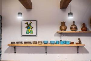 a shelf with bowls and vases on a wall at Casa Rita! Relaxing two bedroom getaway! in Puerto Escondido