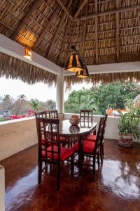 a dining room with a table and chairs and a ceiling at Casa Bella Brisa in Puerto Escondido +35 photos