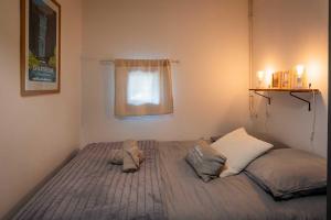 a bed in a small room with a window at La p'tite Lulu in Le Petit Chenevey