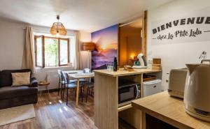 a living room with a kitchen and a dining room at La p'tite Lulu in Le Petit Chenevey