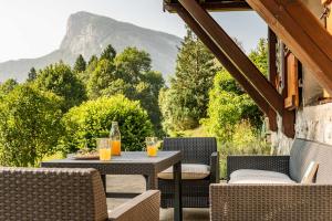a patio with a table with glasses of orange juice at La p'tite Lulu in Le Petit Chenevey