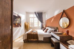 a bedroom with a bed and a mirror at GreenMeadow Central Boutique in Da Lat +37 photos