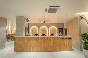 a lobby of a salon with a reception counter at Aura Inn & Suites in Mysore