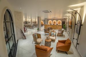 a lobby with a lot of chairs and tables at Aura Inn & Suites in Mysore