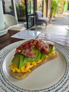 a sandwich on a white plate on a table at Krabi Aonang happy resort in Ao Nam Mao