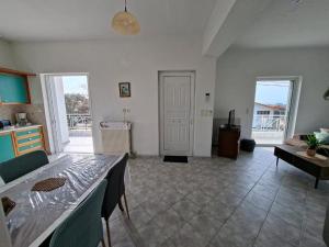 a large living room with a table and chairs at APARTMENT Sonia in Análipsis +16 photos