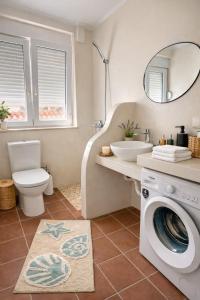 a bathroom with a washing machine and a sink at Koralis in Petra +4 photos