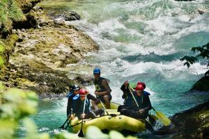 a group of people on a raft in a river at Rafting Camp Palfau in Palfau
