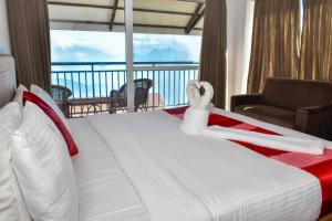 a bedroom with a bed with a view of the ocean at Chill Berg Resort - Bodimettu in Theni +80 photos