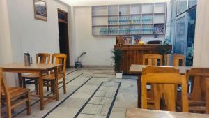 a dining room with wooden tables and chairs at Suket homestay in Jhungi