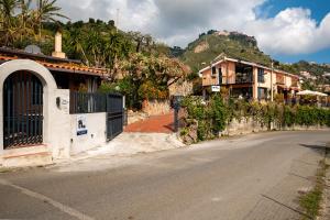 an empty street with a house and a mountain at B&B Tirreno- Finestra sul Mare in Contrada Mastrissa