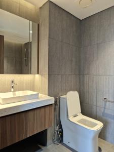 a bathroom with a toilet and a sink at Swanbay - Rice's House in Nhơn Trạch +22 photos