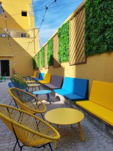 a row of colorful chairs and tables on a patio at Safestay Naples Materdei in Naples