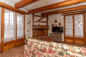 a living room with a couch and a fireplace at Tabia Maredane in Falcade