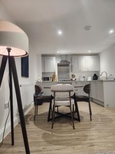 a kitchen with a table and chairs in a room at Seashell Retreat in Bournemouth