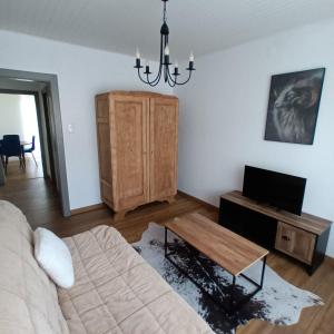 a living room with a couch and a coffee table at charming apartment in Stiring-Wendel