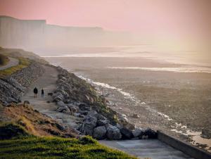 two people walking down a path next to the ocean at 11- Clapotis de l'Ô - Balcon sur la Mer - Parking Privé in Ault +57 photos