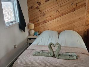 a bed with two heart shaped towels on it at The Cottage in Brædstrup
