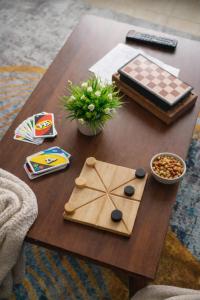 a wooden table with a chess board on it at Cozy Rooms JKIA -Games Nights - Gated - Secure -3 Bedroom -5 Beds -2Baths -15Mins to JKIA-SGR in Syokimau