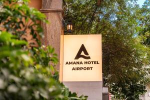 a sign for an amana hotel airport on a pole at Amana Hotel Airport in Ho Chi Minh City