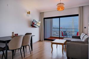 a living room with a couch and a table at Körfez Apart in Fethiye