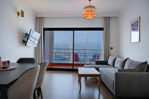 a living room with a couch and a table at Körfez Apart in Fethiye