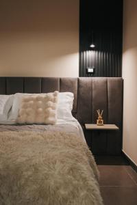 a bedroom with a large bed with a brown headboard at Artemide Suite Spa in Lido Di Fondi
