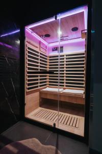 a room with a glass box with a bench in it at Artemide Suite Spa in Lido Di Fondi +26 photos