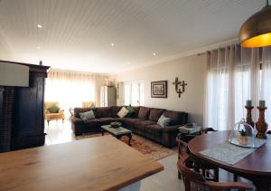 a living room with a couch and a table at AllesWells in Yzerfontein