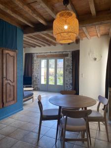 a dining room with a table and chairs at Gîte Asaliah in Sainte-Colome