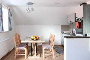 a kitchen with a table and chairs in a room at Bled Castle View Apartment Medina in Zgornje Gorje