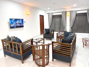 a living room with couches and chairs and a table at Royal Star Guest House in Jaffna