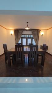 a dining room with a table and some chairs at Royal Star Guest House in Jaffna +9 photos