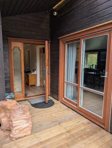 a porch of a house with sliding glass doors at Rasteplassen in Stordalen