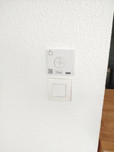 a white light switch on a white wall at Chez Swan et Yuliya in Mooslargue