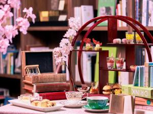 a table topped with plates of food and books at Shiba Park Hotel in Tokyo +57 photos
