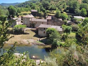 an aerial view of a village with a pond at Maison Emile Teissier in Vébron