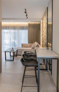 a living room with tables and a couch at Aqua Lora in Nikiana +70 photos