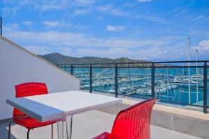 a balcony with a table and chairs and a view of a marina at Körfez Apart in Fethiye