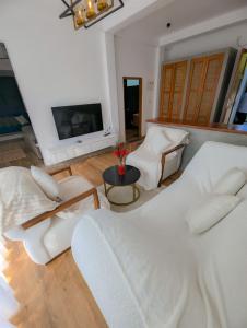 a living room with a large bed and a tv at White Tree Apartment in Bentota