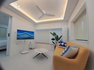 a living room with a couch and a tv at Stay Ali in Gyeongju