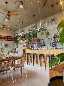 a restaurant with chairs and a bar with plants at Jinjer Resort in Cavinti