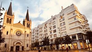 a church and a white building with a tower at - Magnifique appartement climatisé 92m2, spacieux et cosy, au cœur de Vichy in Vichy
