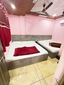 two mattresses in a room with two beds at Shree Kulluka Guest House Ujjain in Ujjain