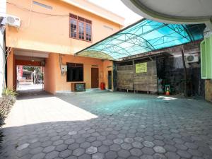 an empty courtyard of a building with a glass roof at RedDoorz @ Seturan Raya in Yogyakarta